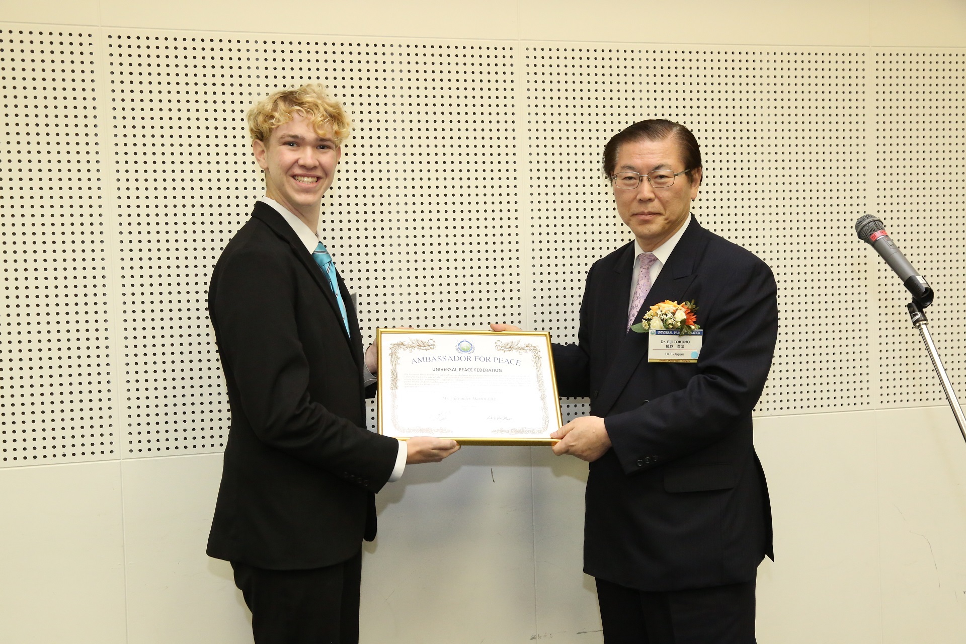 Alex receiving the Universal Peace Ambassador Award